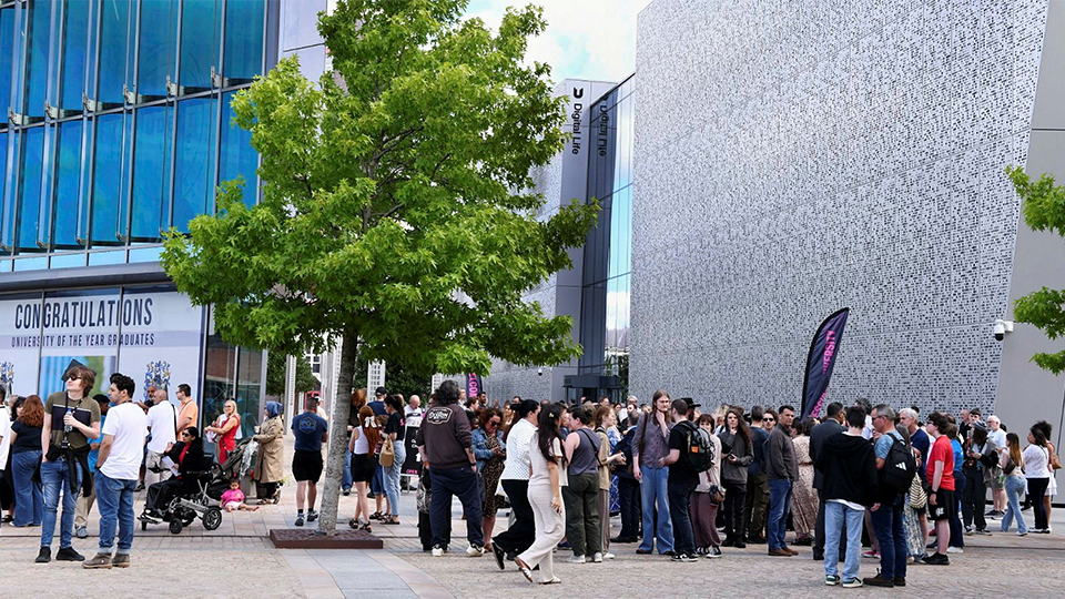 Visitors at an open day with the Student Life and Digital Life buildings