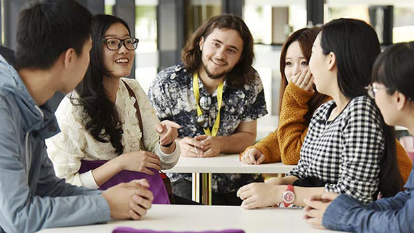 International students sitting and working together in the library at Teesside University