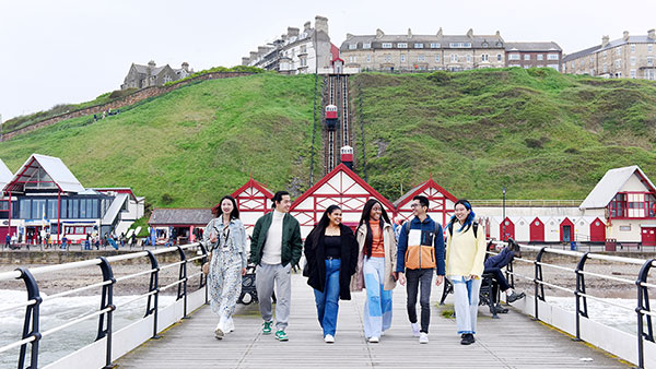 International students walking at Saltburn Pier