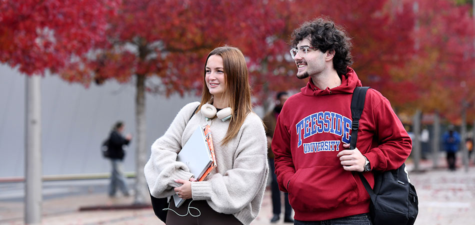 Teesside University postgraduate students talking on Campus Heart