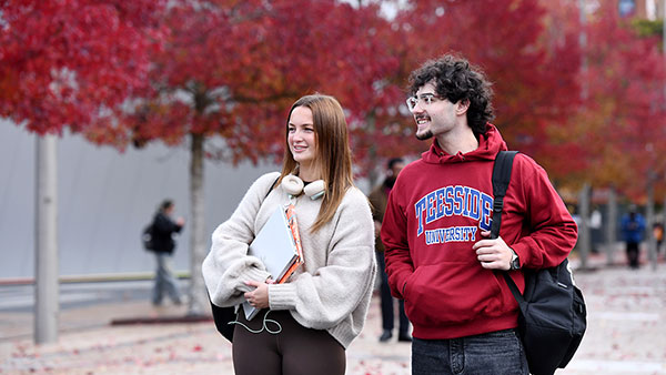 Teesside University postgraduate students talking on Campus Heart