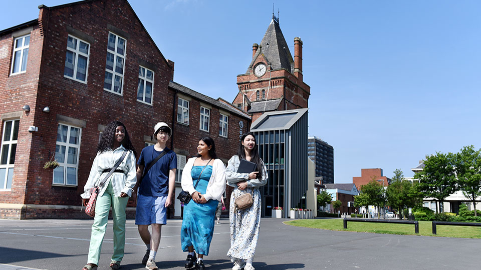 Postgraduate students walking on campus near the Buttery building at Teesside University