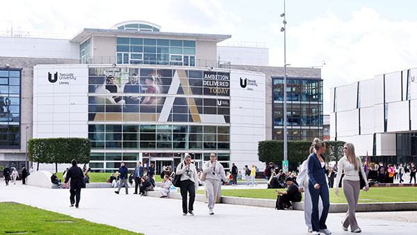 Visitors walking through Teesside University's Campus Heart during a postgraduate open day