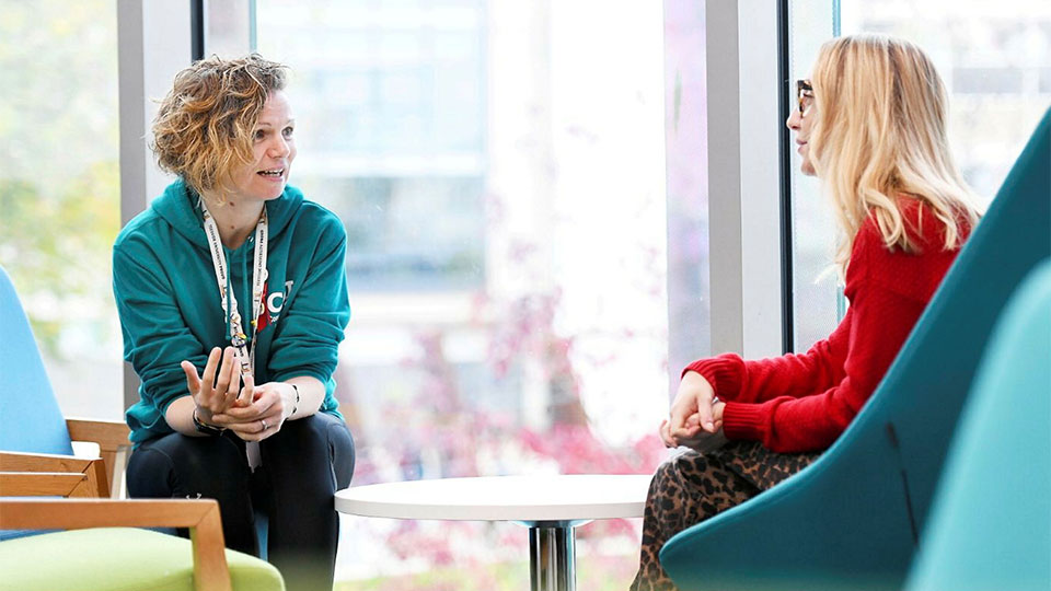 Student talking to a member of University staff
