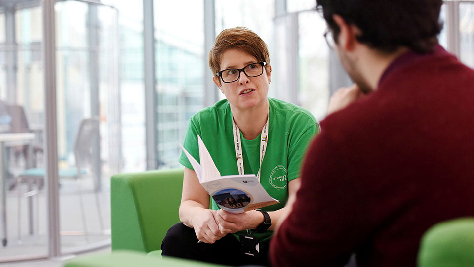 Student talking to a member of University staff