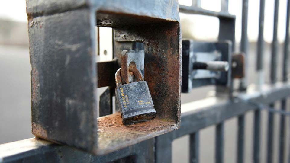 Close-up of a gate with a padlock
