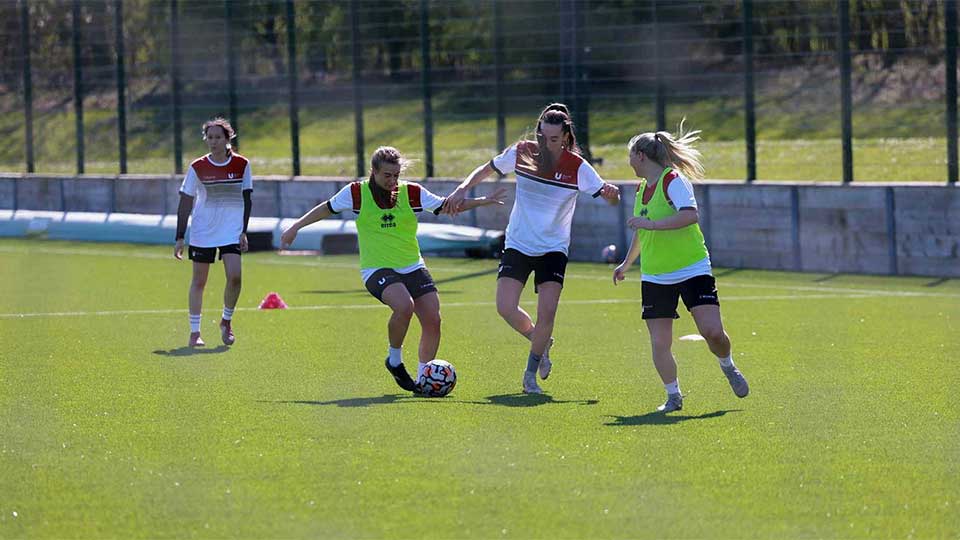 Female football players playing on the Teesside University pitch
