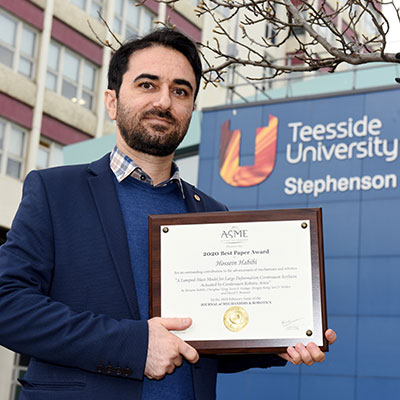 Dr Hossein Habibi holding the 2020 Best Paper Award at Teesside University