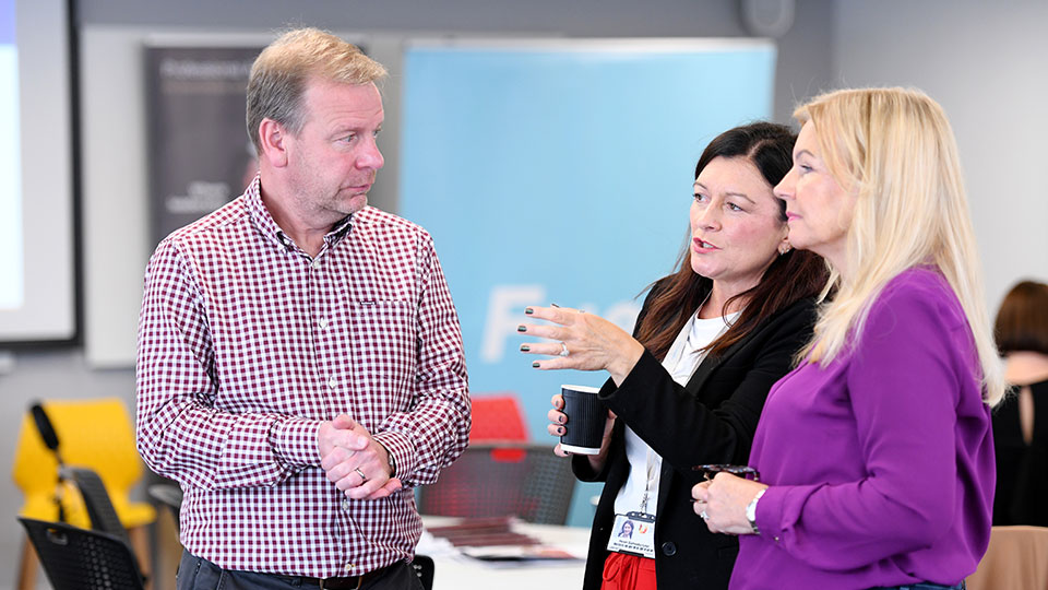 Teesside University alumni engaging in conversation at an alumni event