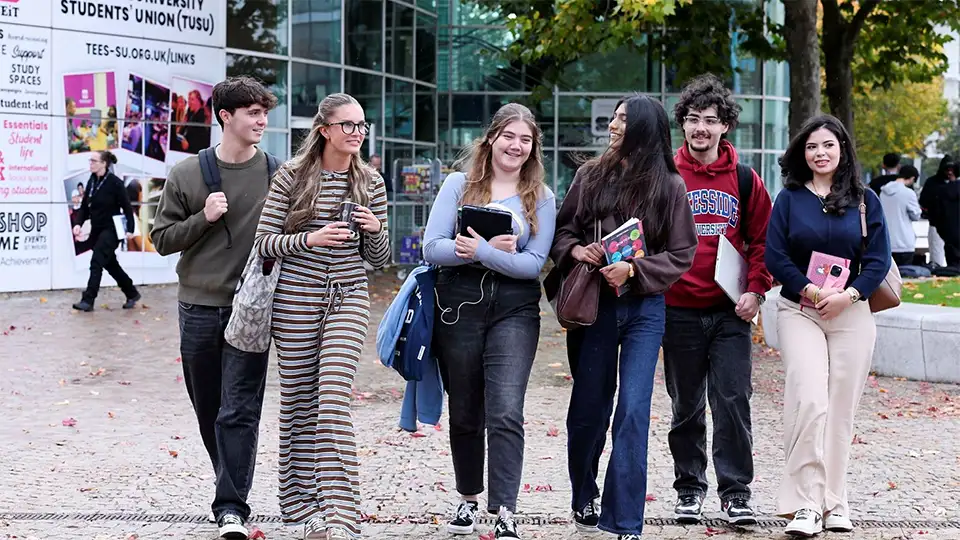 Teesside University students walking in a group on campus
