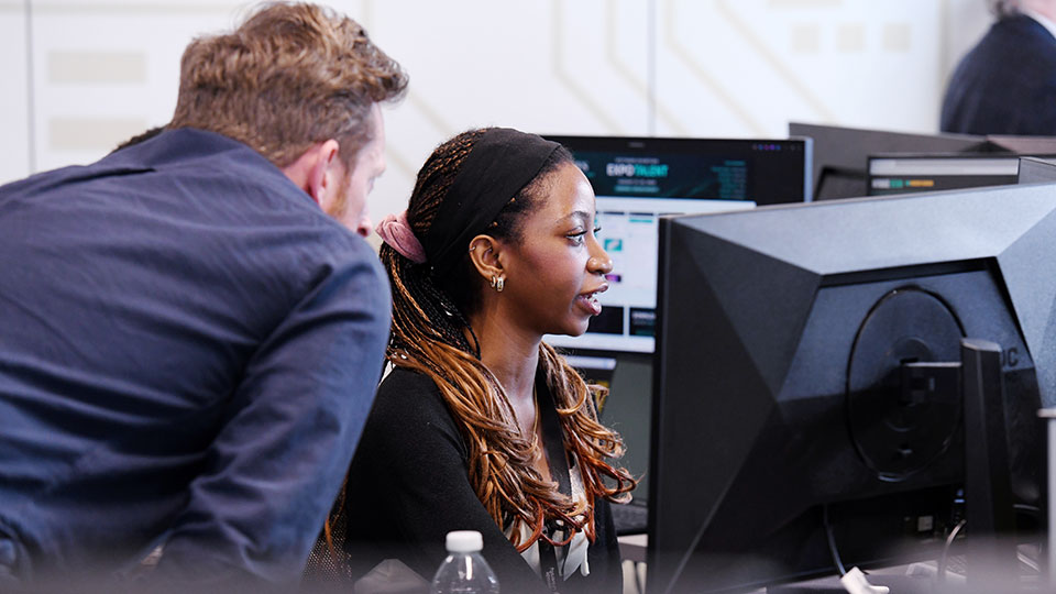 Staff and students in a lab working with computers