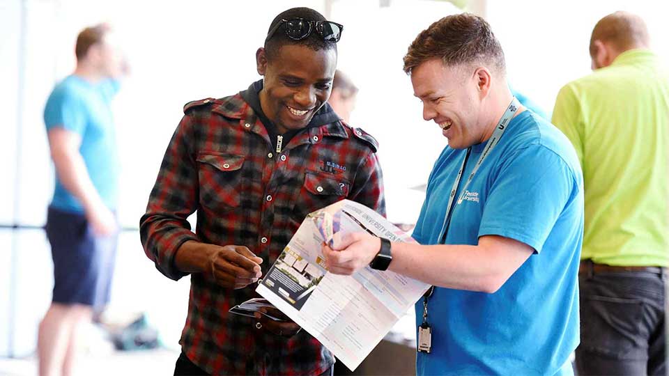 Student getting advice at an open day. Link to Book an open day.