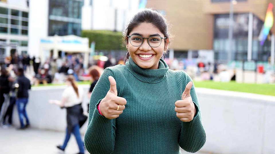 Student on campus. Link to Undergraduate study.