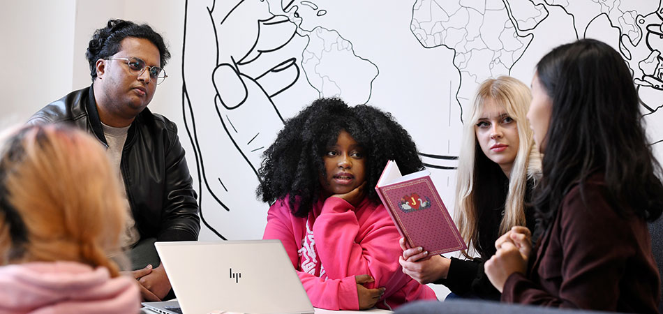 Students studying and sitting together in the library at Teesside University