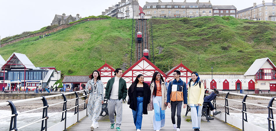International students walking at Saltburn Pier
