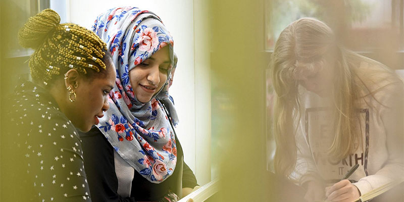 A group of international students at Teesside University discussing fees and funding