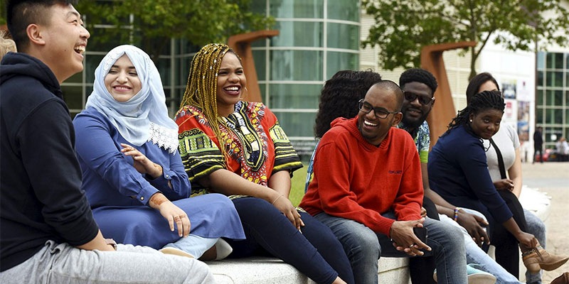 International students sitting and talking in the Campus Centre at Teesside University