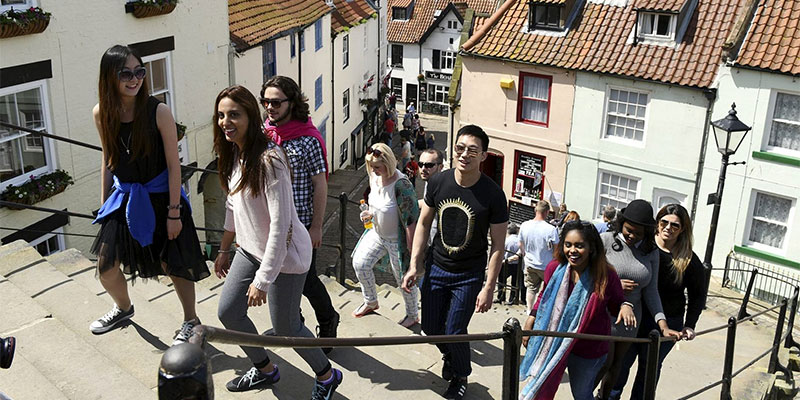 International students walking up the stairs in Whitby during a trip