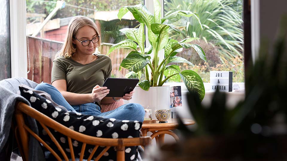 Student using a tablet for online study off-campus
