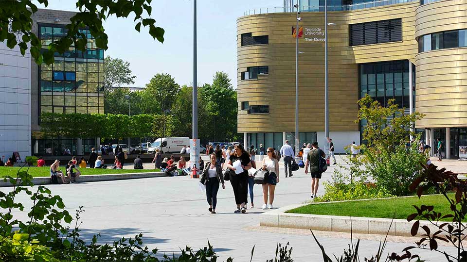 View of The Curve and campus library at Teesside University with students walking