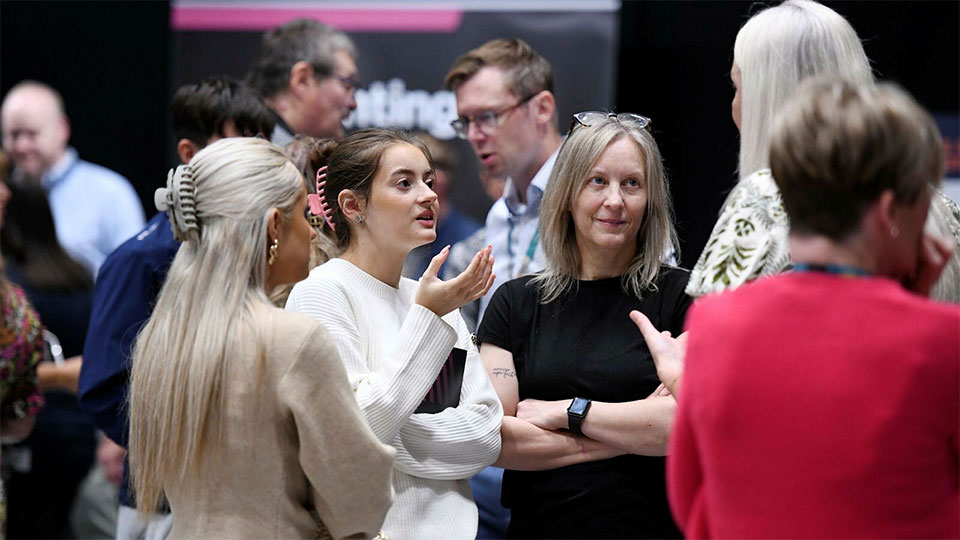Parents talking with staff at an open day