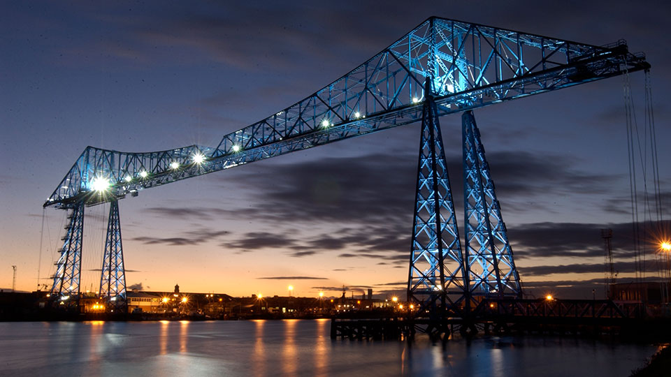 Middlesbrough Transporter Bridge representing Teesside's heritage and landscape. Link to Learn how Teesside University connects people and place through research.