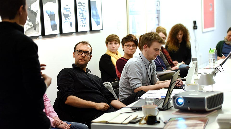 Students and staff seated in a classroom engaged in academic discussion at Teesside University