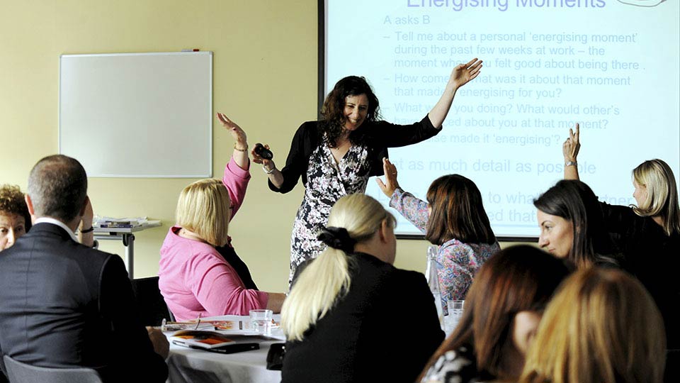 Staff and attendees engaged in a conference session at Teesside University