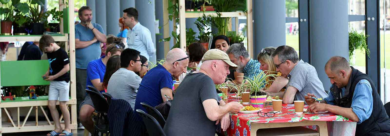 People enjoying food and socializing during an event at MIMA (Middlesbrough Institute of Modern Art)