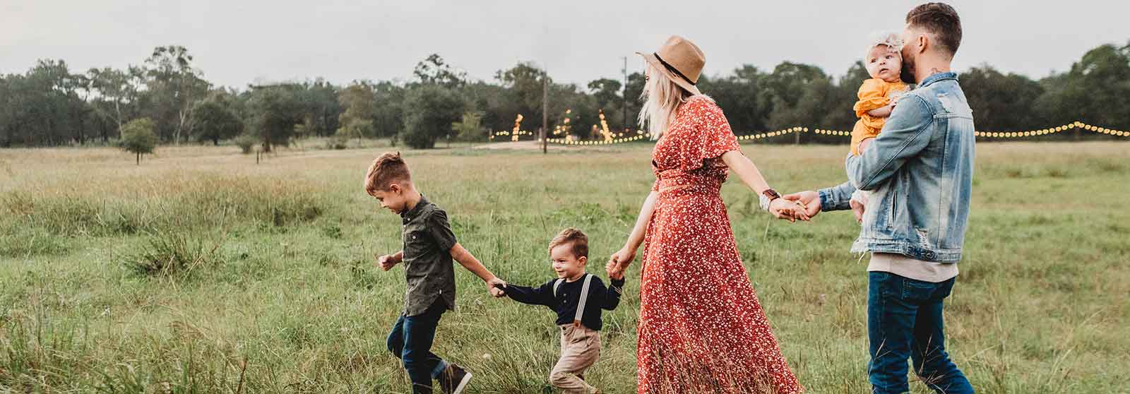 Family with three children walking together in a forest, enjoying nature