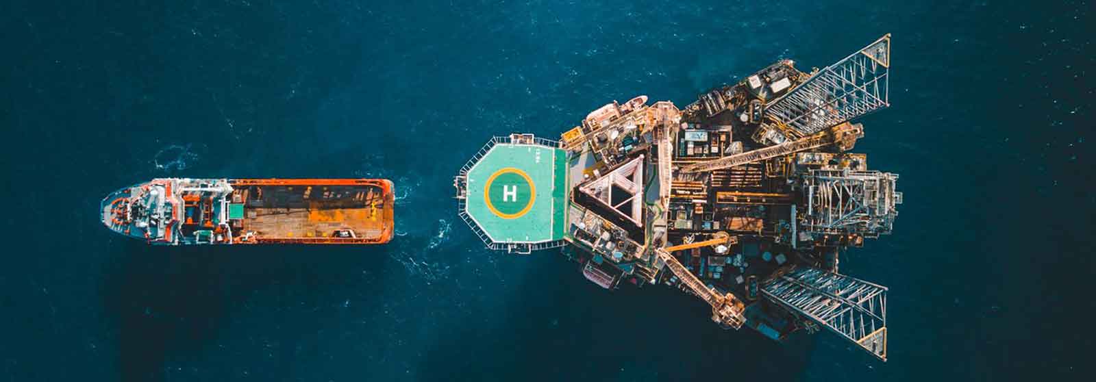Aerial view of jack up rig with towing vessel during towing operation