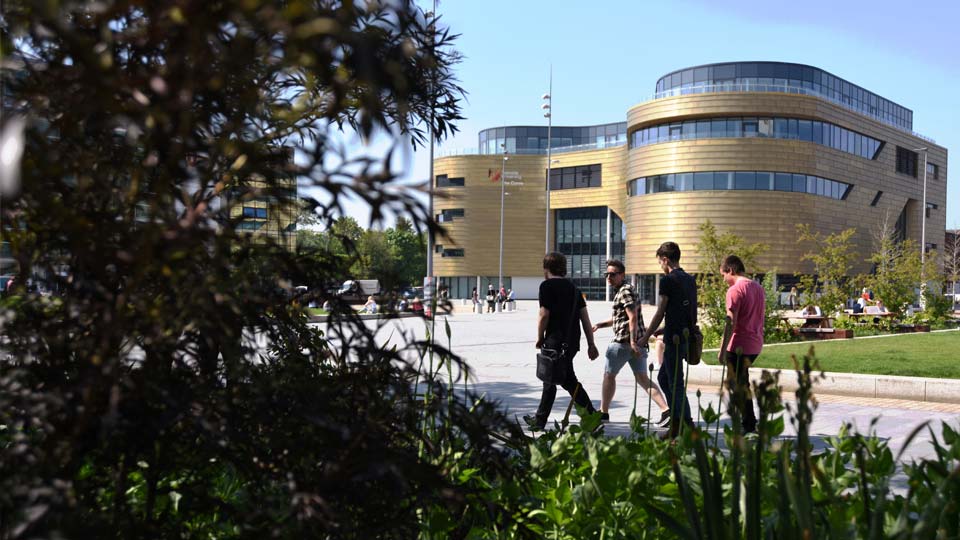 Students walking on campus heart