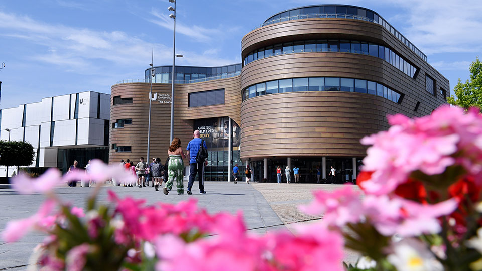 Teesside University campus heart with The Curve and Bios buildings and students walking