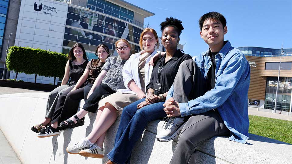 Teesside University student content creators sitting and collaborating at Campus Heart