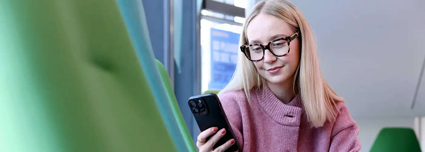 Student on mobile phone in Student Life Building