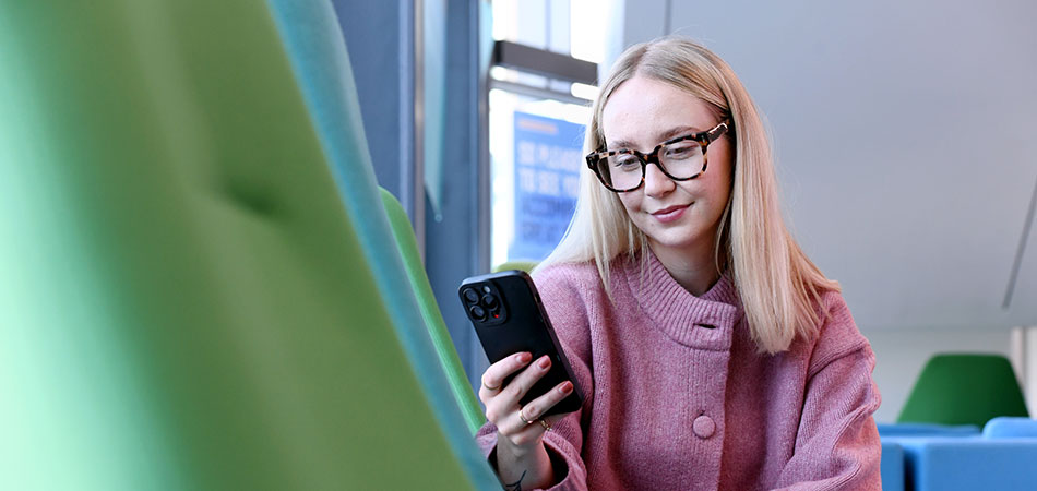Student on mobile phone in Student Life Building