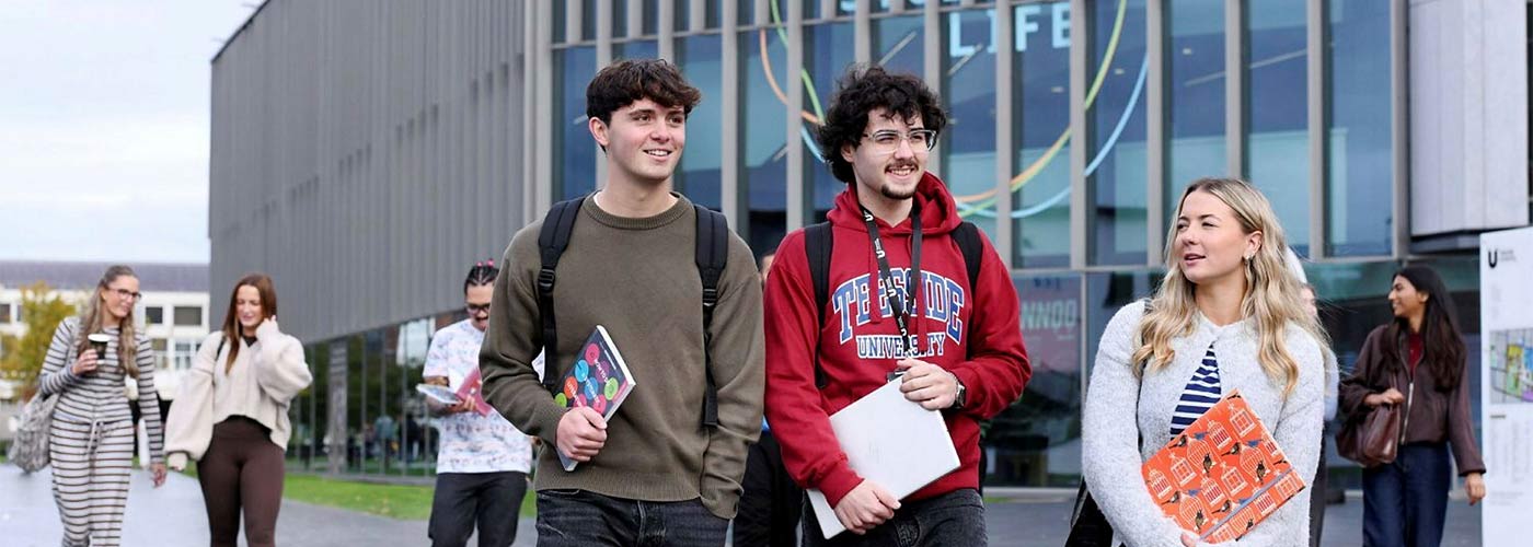Student support advisor speaking with a student in the Student Life Building, Teesside University