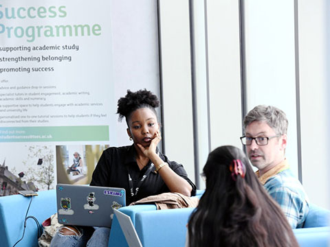 Students collaborating on a laptop in a modern study lounge at Teesside University