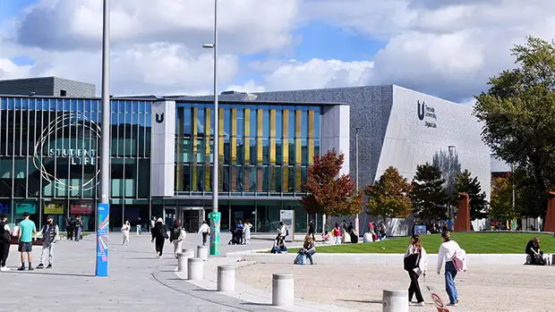 Teesside University campus showing Student Life and Digital Life buildings with students walking and relaxing outdoors