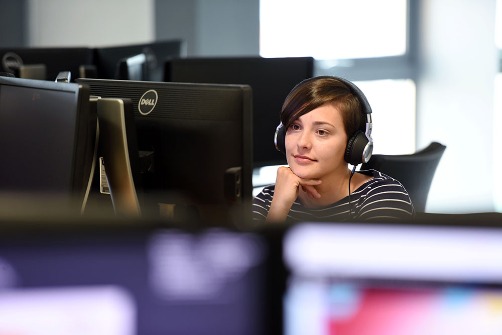 Computing student working in a computer lab