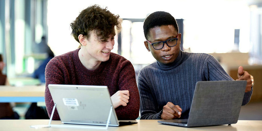 TU Prague City Study Centre students studying together with a tablet