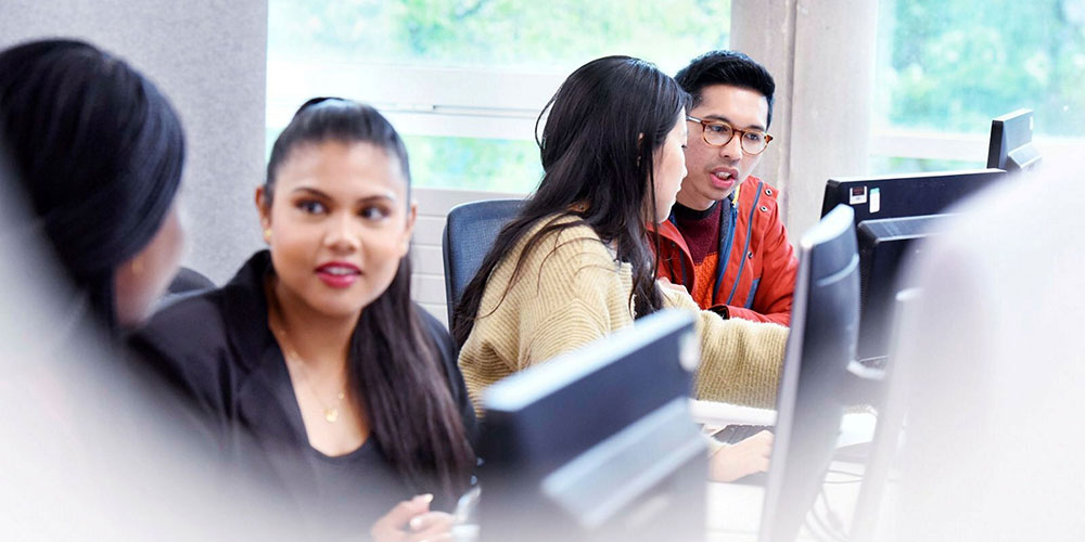 Students studying together with a computer