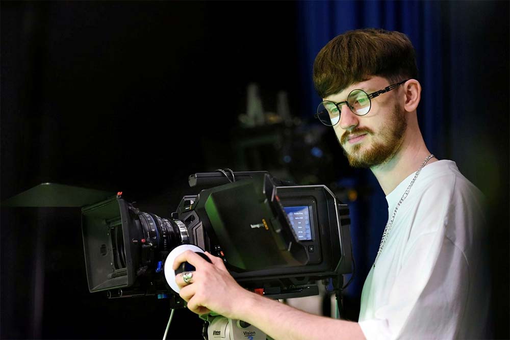 Student using a piece of filming equipment.